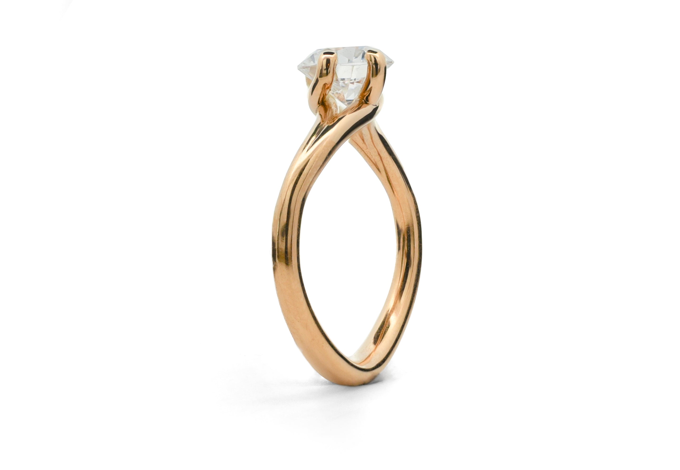 Rose gold Embrace ring with a diamond on a white background