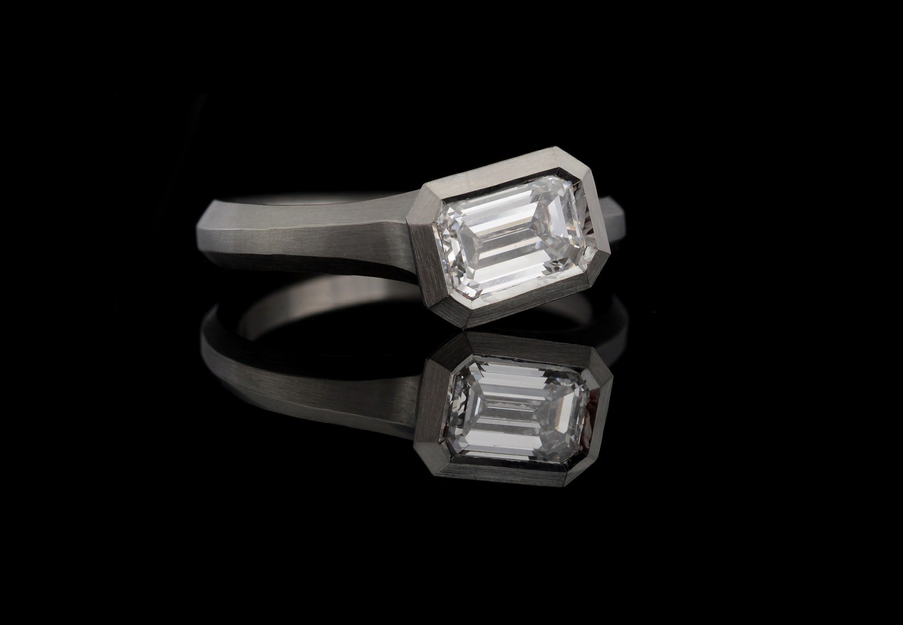 Arris platinum engagement ring with white emerald cut diamond