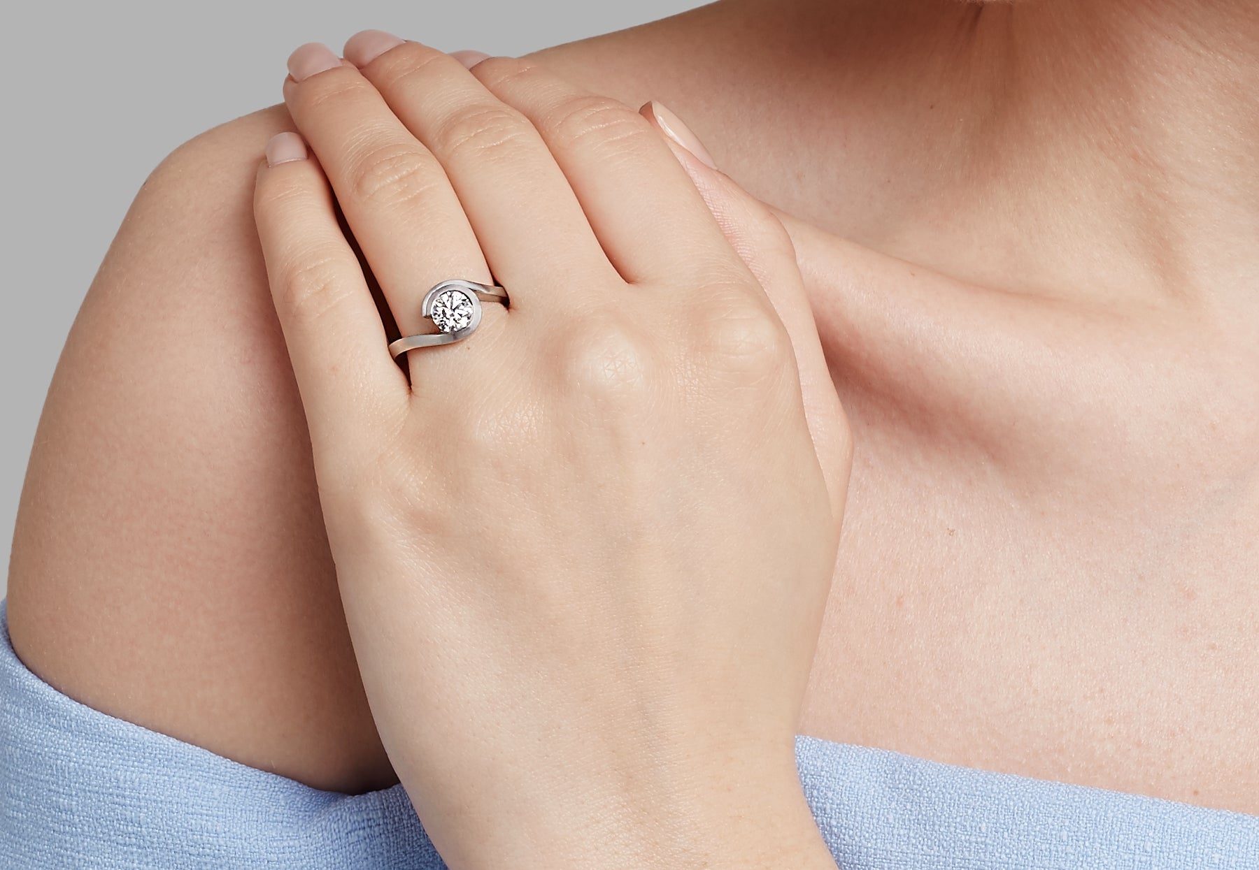 White diamond platinum wave engagement ring on hand