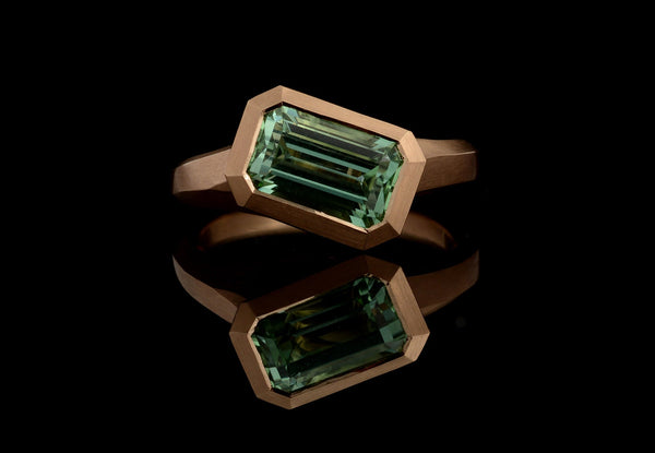 Carved rose gold arris ring with emerald cut mint green tourmaline