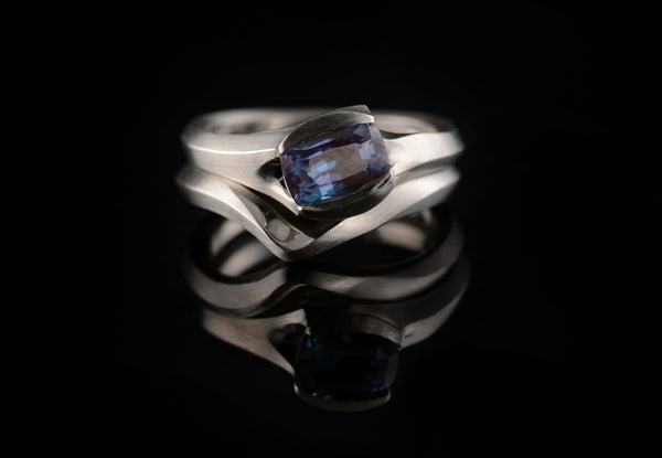 Carved platinum and alexandrite engagement ring and fitted wedding band