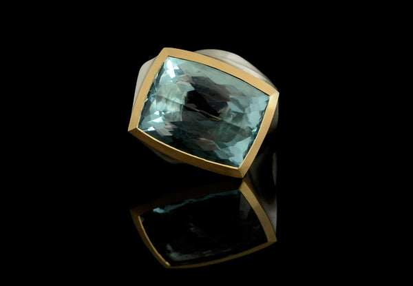 Bespoke silver and gold cocktail ring with large blue gemstone